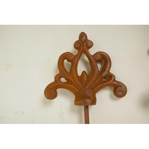 27 - Eight Gothic style decorative iron plant stakes, 42½