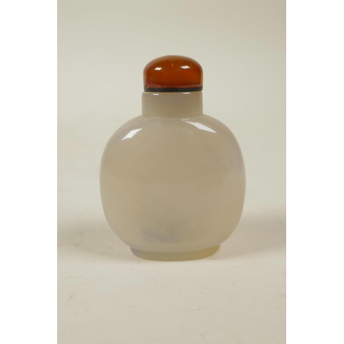 28 - A Chinese agate snuff bottle with carved butterfly, bird and lotus flower decoration, 2½