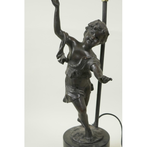 34 - A bronzed metal table lamp cast as a figure of a dancing girl on a plinth base, 17