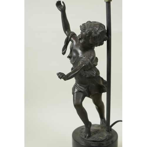 34 - A bronzed metal table lamp cast as a figure of a dancing girl on a plinth base, 17