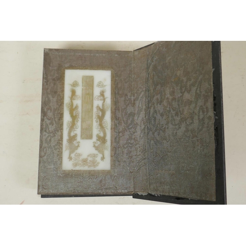 35 - A Chinese hardwood and silk bound book containing white jade tablet pages with engraved and gilt cha... 