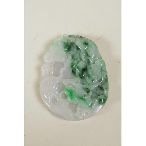 40 - A Chinese carved mottled green jade pendant with carp and lotus flower decoration, and another green... 