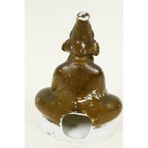 43 - A Continental porcelain pastille burner modelled as a figure seated in meditation, 4