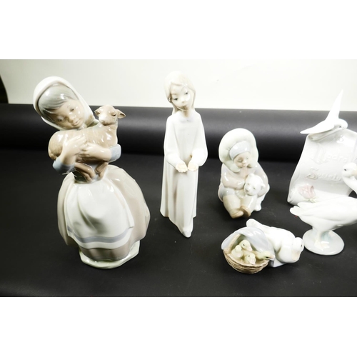 47 - A collection of six Lladro collector's items; Baby Jesus, no.14535, Eskimo child with polar bear cub... 