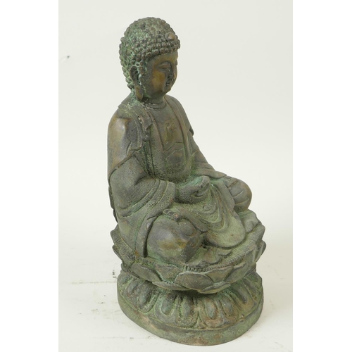 49 - A Chinese bronze figure of Buddha seated in meditation on a lotus throne, having green patination, 8... 