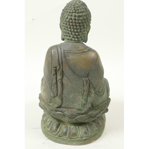 49 - A Chinese bronze figure of Buddha seated in meditation on a lotus throne, having green patination, 8... 