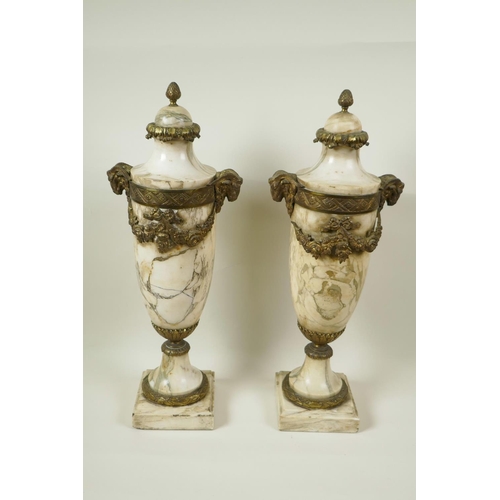 5 - A pair of marble urns with gilt metal mounts and applied garlands, with cast goat mask handles, 18½