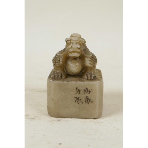 50 - A Chinese soapstone seal with carved dragon knop and character inscription to side, 2