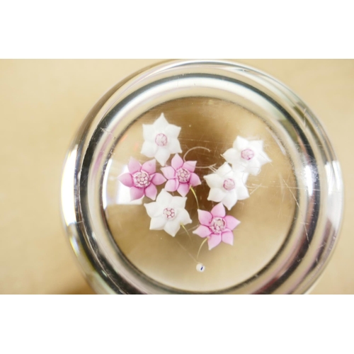 52 - A pink and white florally decorated paperweight, signed, 3