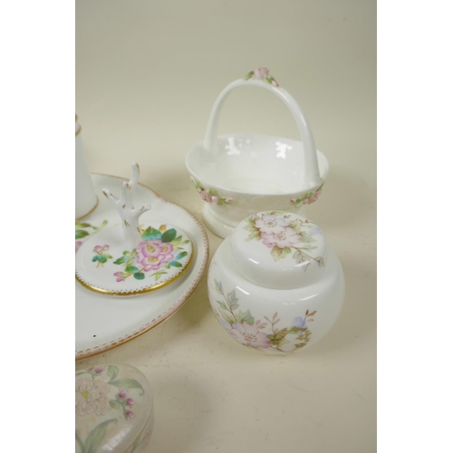 56 - A collection of decorative porcelain including a floral decorated dressing table set, tray 11