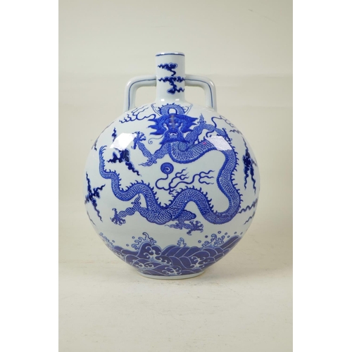 58 - A Chinese blue and white porcelain two handled moon flask decorated with a dragon and the flaming pe... 