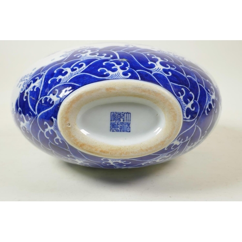 58 - A Chinese blue and white porcelain two handled moon flask decorated with a dragon and the flaming pe... 