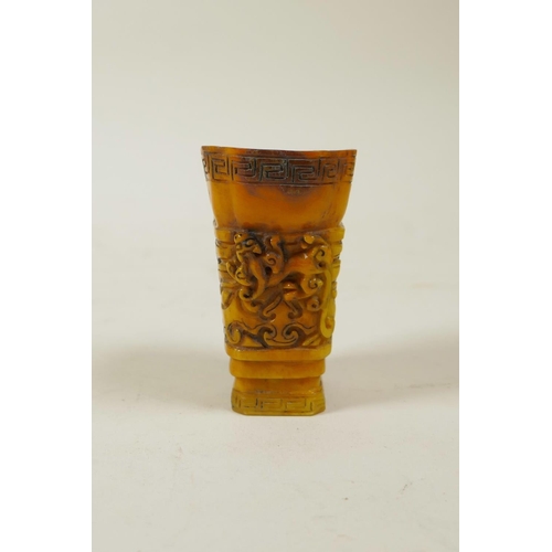 60 - A Chinese carved horn libation cup with kylin decoration, 2½