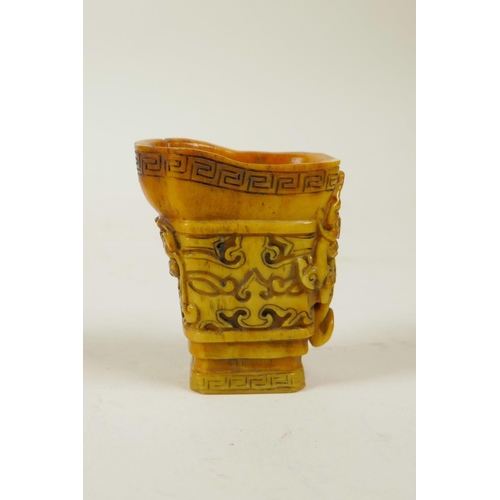 60 - A Chinese carved horn libation cup with kylin decoration, 2½