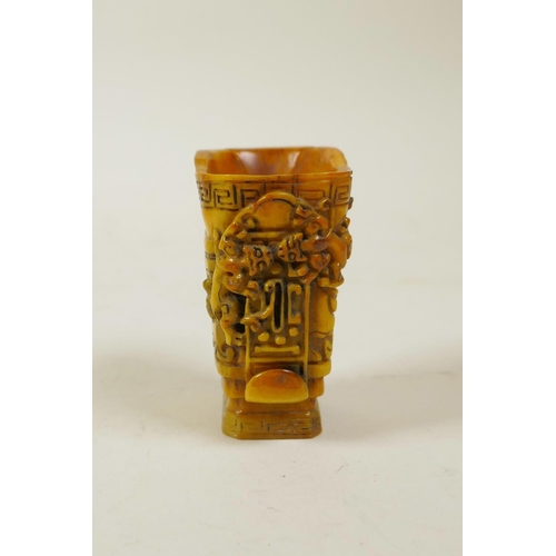 60 - A Chinese carved horn libation cup with kylin decoration, 2½