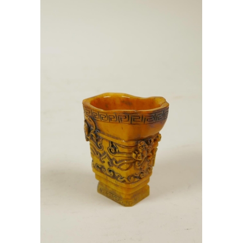 60 - A Chinese carved horn libation cup with kylin decoration, 2½