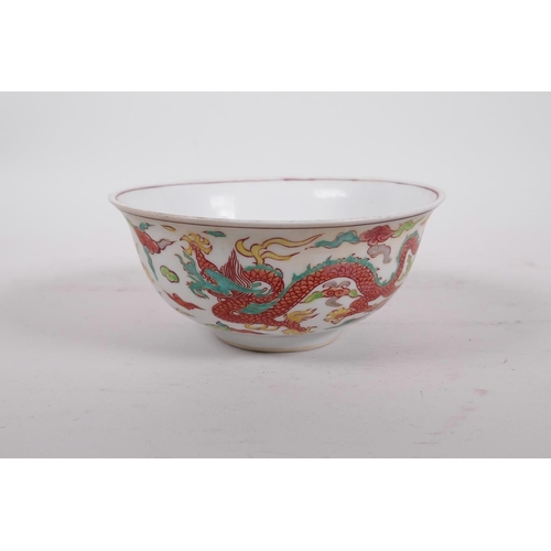 195 - A Chinese polychrome porcelain rice bowl decorated with dragons to exterior and a phoenix to the bow... 