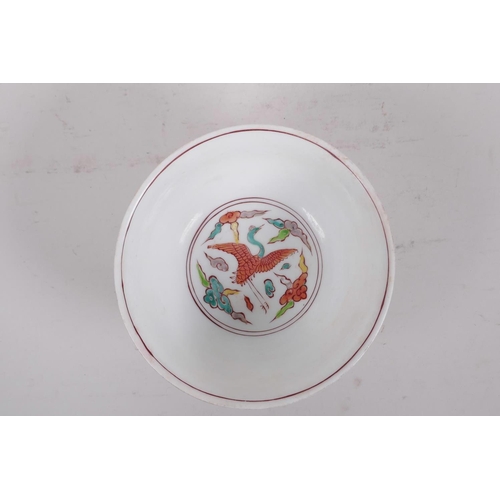 195 - A Chinese polychrome porcelain rice bowl decorated with dragons to exterior and a phoenix to the bow... 