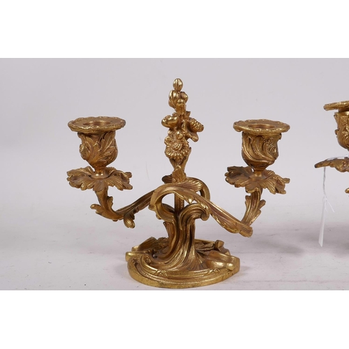 27 - A pair of gilt brass two branch rococo style dwarf candlesticks, 6