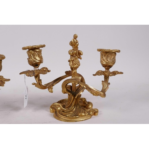 27 - A pair of gilt brass two branch rococo style dwarf candlesticks, 6