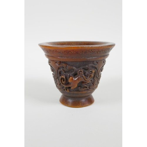 28 - A Chinese faux horn libation cup with carved kylin handles, impressed seal mark to base, 3