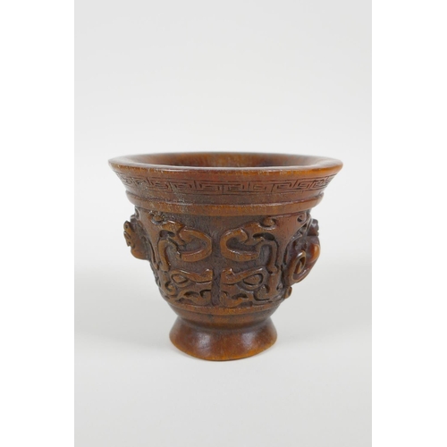 28 - A Chinese faux horn libation cup with carved kylin handles, impressed seal mark to base, 3