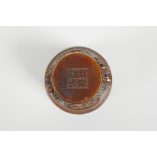 28 - A Chinese faux horn libation cup with carved kylin handles, impressed seal mark to base, 3