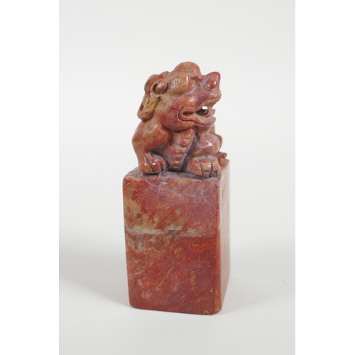 38 - A Chinese red soapstone seal with a carved kylin knop, 3