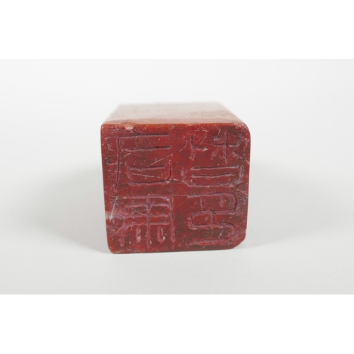 38 - A Chinese red soapstone seal with a carved kylin knop, 3