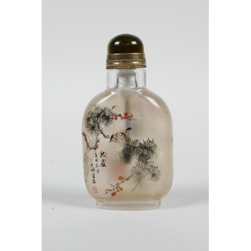 103 - A Chinese reverse decorated glass snuff bottle depicting birds perched on branches in bloom, 3