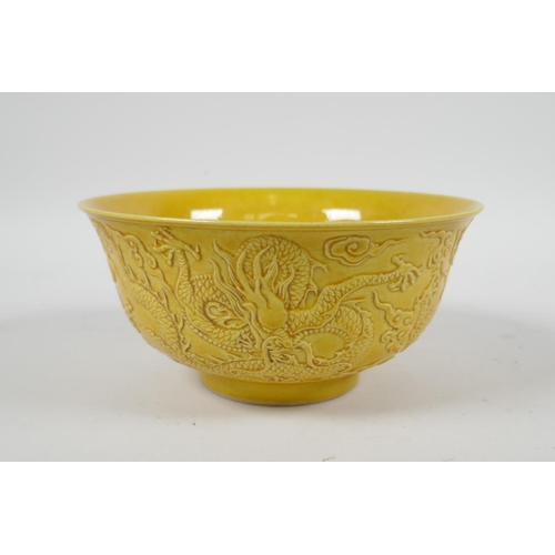 105 - A Chinese yellow ground porcelain rice bowl with raised dragon decoration, 6 character mark to base,... 