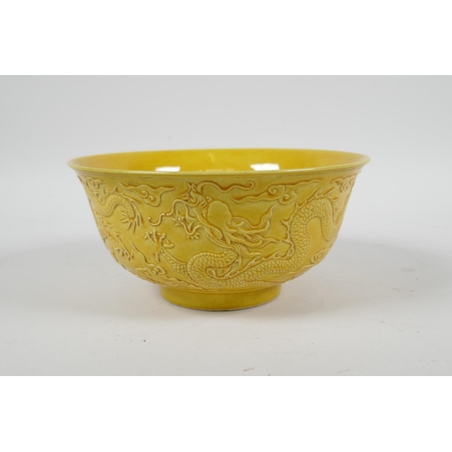 105 - A Chinese yellow ground porcelain rice bowl with raised dragon decoration, 6 character mark to base,... 