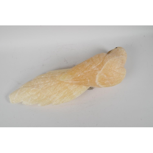 107 - A carved yellow quartz figure of a parrot, 17½