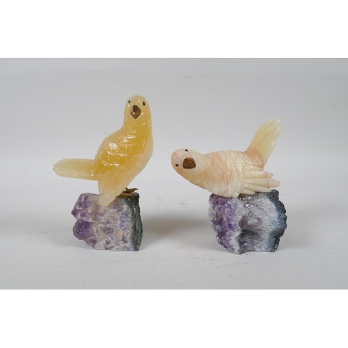 109 - Two carved yellow quartz birds on amethyst bases, 5½