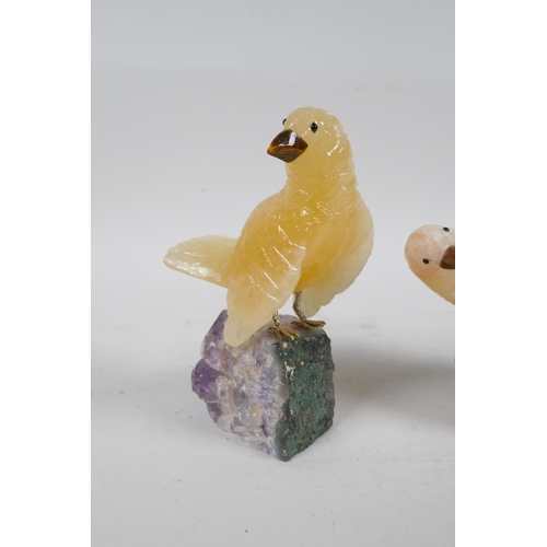 109 - Two carved yellow quartz birds on amethyst bases, 5½