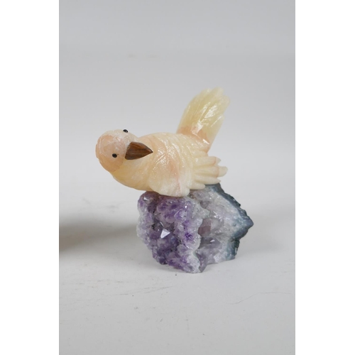 109 - Two carved yellow quartz birds on amethyst bases, 5½