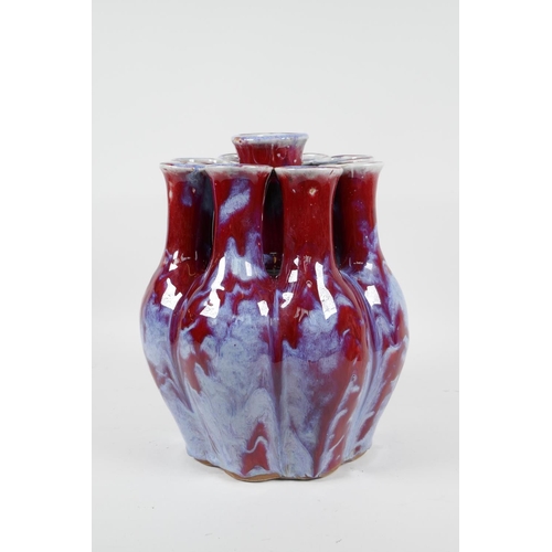 111 - A Chinese flambe glazed porcelain nine section tulip vase, 9½