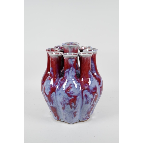 111 - A Chinese flambe glazed porcelain nine section tulip vase, 9½