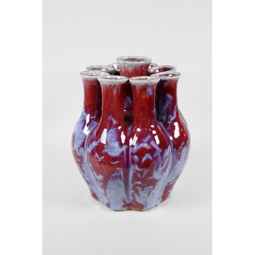 111 - A Chinese flambe glazed porcelain nine section tulip vase, 9½