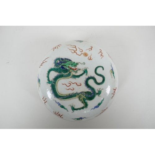 118 - A Chinese famille verte porcelain circular box and cover decorated with a dragon and flaming pearl, ... 