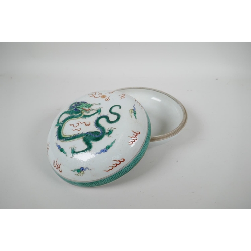 118 - A Chinese famille verte porcelain circular box and cover decorated with a dragon and flaming pearl, ... 