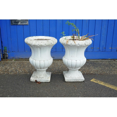 1198 - A pair of painted concrete garden urns, 22½