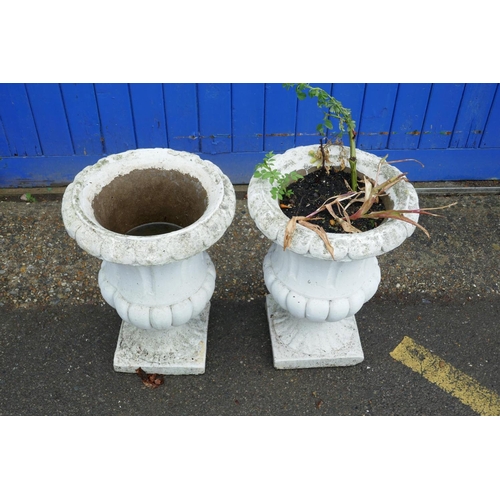 1198 - A pair of painted concrete garden urns, 22½