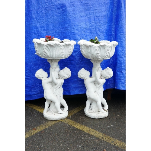 1199 - A pair of painted concrete raised garden planters, the planters held aloft by two cherubs, 36