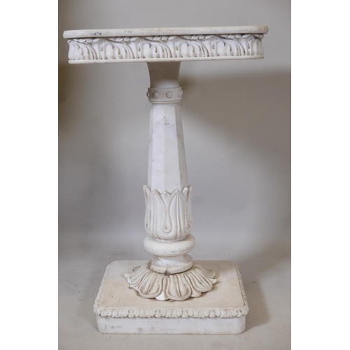 1214 - A marble pedestal with carved frieze top, raised on a tapering column with lotus leaf decoration, A/... 