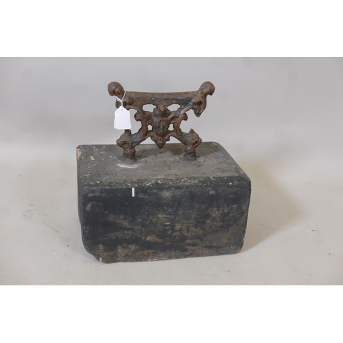 1215 - An antique wrought iron bootscraper mounted on a painted stone base, 12