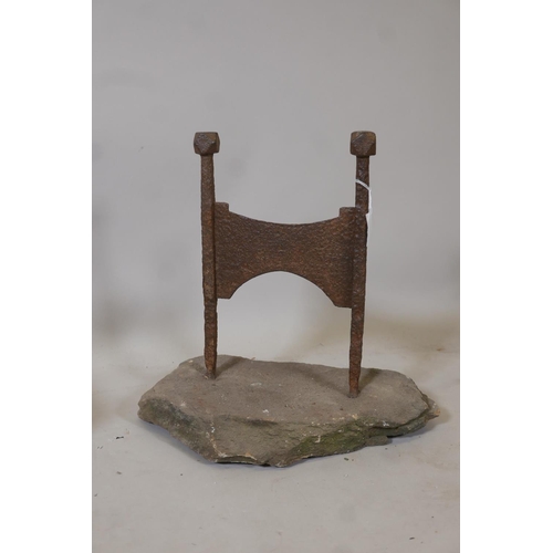 1216 - An antique wrought iron bootscraper mounted on a stone base, 16