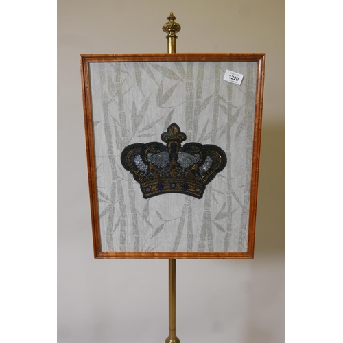 1220 - A Victorian bird's eye maple polescreen, with carved column and triform platform base with scroll su... 