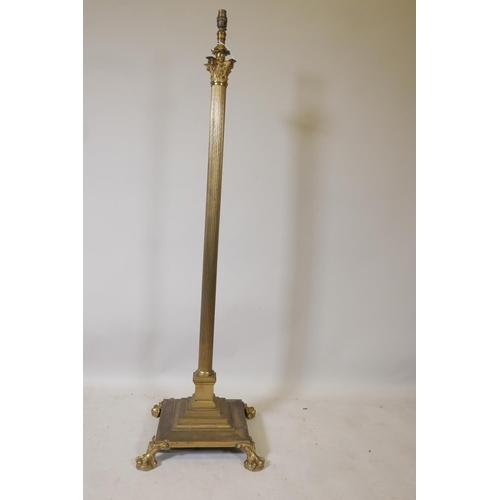 1221 - A Corinthian column standard lamp with stepped platform base and paw feet, 53