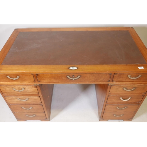 1222 - A Starbay hardwood maritime style, nine drawer pedestal desk, with inset campaign style handles and ... 